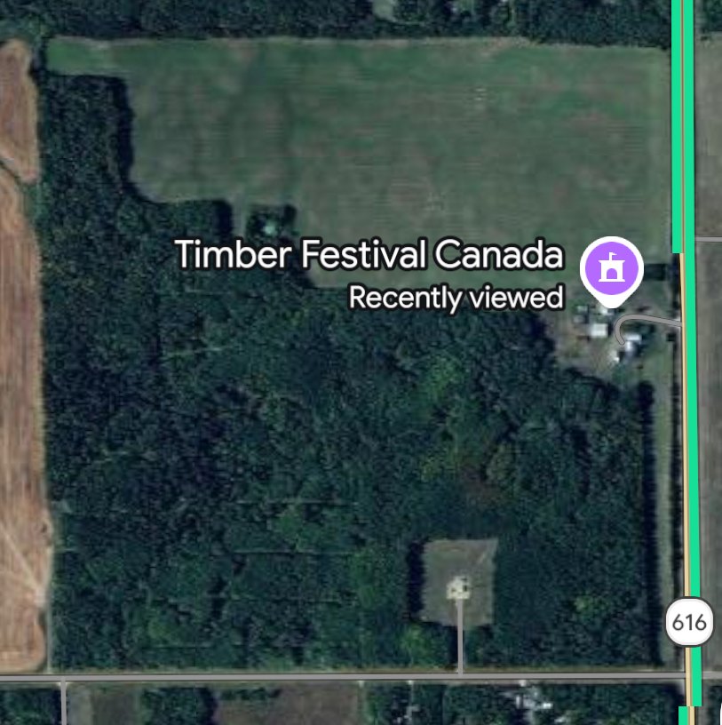 Aerial photograph showing the forested Timber World property beside Highway 616